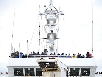 Cruise passengers pack the top deck of the Lyubov Orlova to get a look at polar bears in the Franklin Strait Aug. 30.