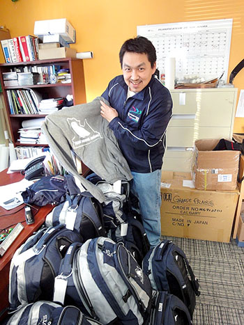 Tunu Napartuk, the recently-appointed director of the Kativik Regional Government’s recreation department, displays the the navy blue, grey and white uniforms that Team Nunavik will wear in Grande Prairie, Alberta at next week’s Arctic Winter Games. (PHOTO BY JANE GEORGE)