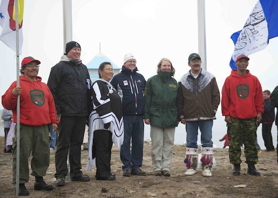 A flag-raising ceremony with the flags of Canada, Norway, Nunavut and Gjoa Haven took place Aug. 23 in Gjoa Haven, with the Amundsen cairn and the community in the background, took place Aug. 23 as part of the welcoming ceremonies for an exhibit on the Norwegian polar explorer, Roald Amundsen. The photo shows local Canadian Rangers in red sweatshirts and from the left Geir Klover, director of the Fram Museum inOslo, Jeannie Ugyuk MLA for Nattilik Jo Sletbak, deputy ambassador at the Norway's embassy in Canada, Rebecca Torretti, regional coordinator, Nunavut Parks, and Joanni Sallerina, mayor of Gjoa Haven.
