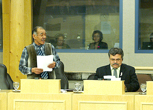 Nunavut's languages minister Louis Tapardjuk speaks in the Legislative Assembly Oct. 26 while Community and Government Services minister Lorne Kusugak listens. Tapardjuk came under fire for announcing the Government of Nunavut will delay implementation of two major pieces of language legislation. (PHOTO BY CHRIS WINDEYER)