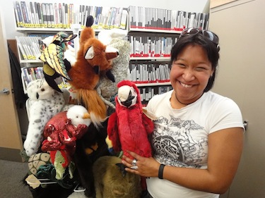 Assistant programs manager Lisa Bachellier shows off some of the puppets recently acquired by the May Hakongak library in Cambridge Bay. (PHOTO BY JANE GEORGE)