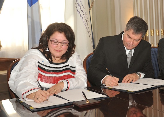 Alasie Arngak, chair of the Nunavik regional board of health and social services, signs an agreement alongside Quebec health minister Yves
Bolduc Feb. 15 in Quebec CIty. The agreement nets the region $280 million in provincial health money over the next seven years. (SUBMITTED PHOTO)