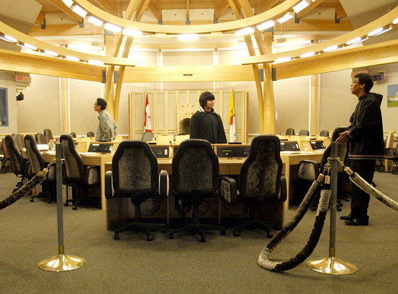 Pages and staff await the opening of Nunavut's Legislative Assembly Feb. 22. MLAs want representatives from the federal government and private sector to sit in the witness chairs, centre, and explain why Nunavut's food prices are so high. (PHOTO BY CHRIS WINDEYER)