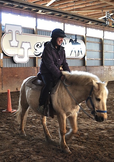 Minnie Molly Snowball tries riding horses for the first time at TJ Stables during a recent student exchange to southern Ontario. The stable owner invited the group for a free lesson when he heard the Inuit students had never seen live horses before. (PHOTO BY GILLIAN WARNER)
