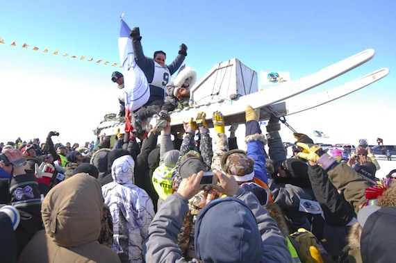 Peter Kiatainaq is hoisted into the air on his sled in Salluit after winning Nunavik's Ivakkak dog team race on April 3. (PHOTO BY PIERRE DUNNIGAN)