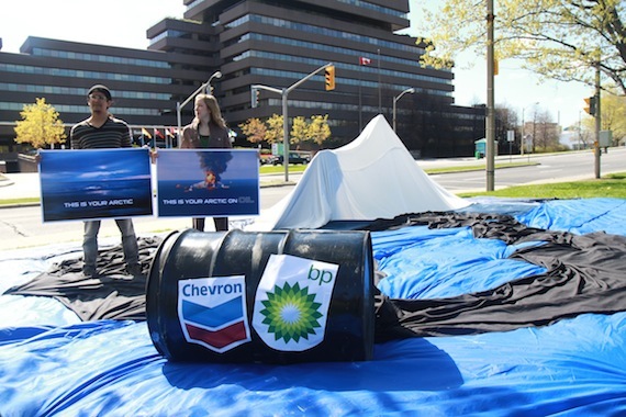 A coalition of environmental groups from Canada, the U.S., Russia, Greenland, Denmark and Norway, which wants the Arctic Council to push for a moratorium on offshore drilling in Arctic waters, demonstrated May 11 in front of the foreign affairs office building in Ottawa where they set up a mocj iceberg floating on a sea covered in oil. (PHOTO/ COUNCIL OF CANADIANS)