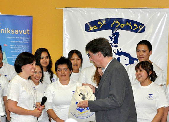 Members of 2011 Nunavut Sivuniksavut graduating class present NS co-ordinator Morley Hanson with a parting gift — a seal skin vest — at the official opening of NS's new home in Ottawa on May 14. About 20 students will receive their NS diplomas at a May 15 graduation ceremony. (PHOTO BY SARAH ROGERS)