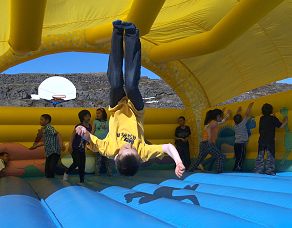 Students at Nanook School in Apex wrapped up their after-school program with an afternoon in an inflatable bouncy castle June 16. Here, Mark Junior Wisintainer, 10, pulls off a backflip. (PHOTO BY CHRIS WINDEYER)
