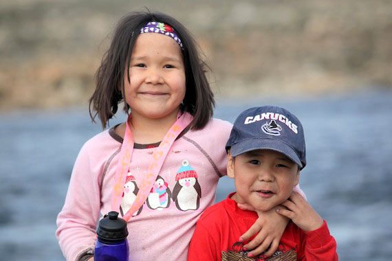 Avi and Ezra Maksagak are all smiles as they enjoy a cook-out with family and friends on a beautiful summer day by the river in Cambridge Bay. (PHOTO BY MILLE TRAUB)