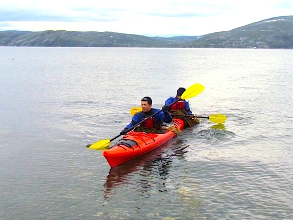James Pilurtuut of Kangiqsujuaq paddled along Wakeham Bay last week as part of a youth leadership workshop held during the Proud Reunions summer camp. This program, now in its third year in Kangiqsujuaq, brings former teachers back to the community to lead week-long workshops for students and team leaders. (PHOTO BY MARION JAMES)