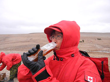 Agatha Pitayuk of Taloyoak joined the Canadian Rangers to learn more land skills. Here she sips on a plastic bag of coffee from her pack of rations while she waits for her turn to practice her new shooting skills. (PHOTO BY JANE GEORGE)