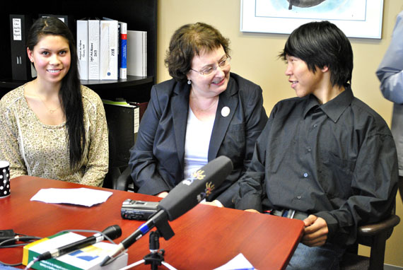 Justice Beverly Browne (centre), who now serves on the Alberta Court of Queen’s Bench, during a visit to Iqaluit this week handed out Upinnaqtuq awards Aug. 18  to two young Nunavut students: Stephanie Matthews (left) and Jason Gibbons (right.) The award, created in Browne’s honour by the Law Foundation of Nunavut, recognizes students from the three Nunavut regions who show leadership in conflict resolution or “remarkable progress in rehabilitation” and comes with a $500 cheque. Browne described Gibbons, 14, as a “pleasant, caring and hard-working young man” who is always willing to help out. Matthews, 18, who graduated from Inuksuk High School this year, served as a youth representative on Iqaluit’s restorative justice committee and will begin studies this fall at Dalhousie University in Halifax. Geela Manning of Kimmirut (not shown) also won an award, along with students from Hall Beach, Rankin Inlet and Taloyoak who cannot be named because the law foundation as yet to receive privacy clearances for them. (PHOTO BY JIM BELL)