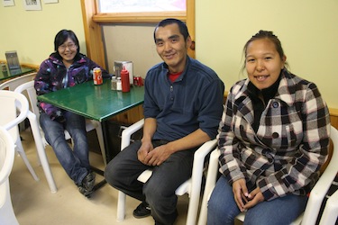 Annpaul Ottokie, 19, Mathewsie Alariaq, 27, Alysia Toonoo, 18, seen here at the Nirivik Co-op, say despite their community's problems, 