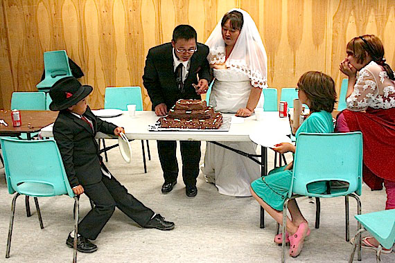 Congratulations to Pitseolaaq Qimirpik and Nirukasiaq Atsiaq of Kimmirut for their recent marriage in Cape Dorset. Here, the couple, who travelled to Cape Dorset from Kimmirut for the event, along with other family members, prepare to serve up their wedding cake.  (PHOTO BY JUSTIN NOBEL)