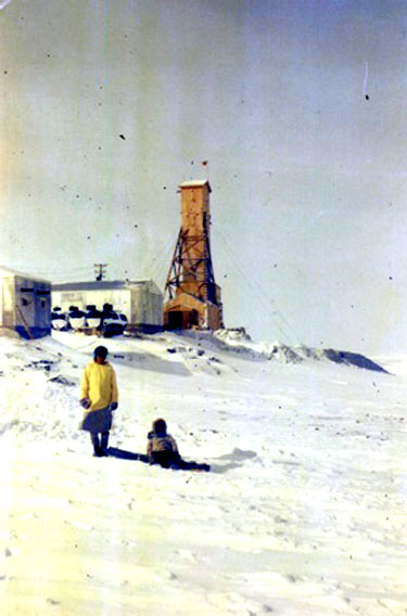 This photo of an Inuit woman and child was taken in front of the North Rankin Nickel Mine the year it opened, in 1957. (GN Archives)