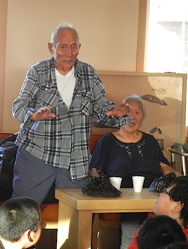 Moses Koihok, who at 91 is the oldest resident of Cambridge Bay, talks to Grade Seven students from Kiilinik High School at Cambridge Bay's Elders Palace on Oct. 6. Students meet with elders once a month for an afternoon there. The group shares a snack and students ask elders questions about how life was when they were young. (PHOTO BY JANE GEORGE)