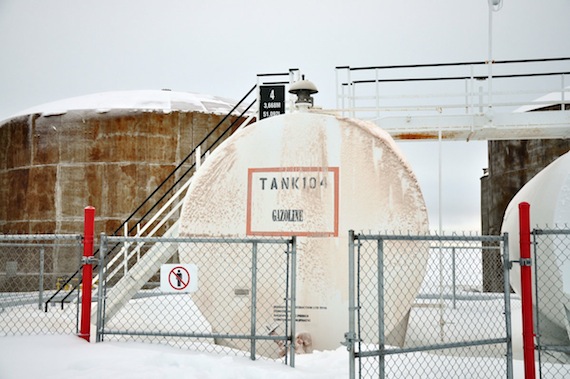Resolute Bay's fuel tank farm, where crews have contained almost 100,000 litres of spilled fuel since last week. The smaller white tank in the foreground draws fuel from the largest tanks and is used to distribute fuel to the public. But sometime late Oct.27, the valves to that tank were opened and fuel spilled out from the bell-like feature at the top of the tank. The spill went unnoticed until early Oct. 28, when RCMP were called to investigate. (PHOTO COURTESY OF RON ELLIOTT)