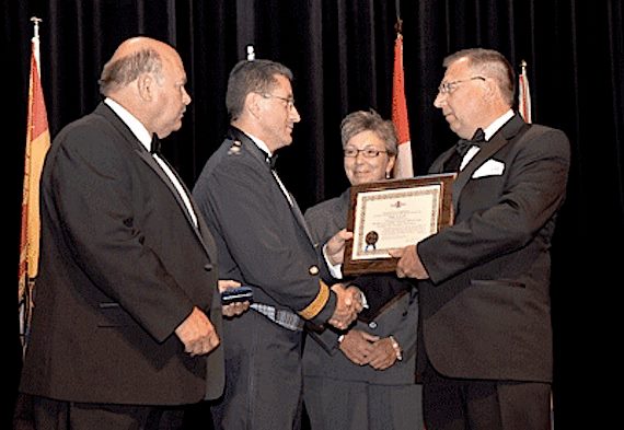 Paul Laserich, seen here at the far right, accepts a plaque at the 2010 ceremony inducting his late father, aviation pioneer Willy Laserich of Cambridge Bay, into Canada's aviation hall of fame. Paul Laserich, 52, the general manager of Adlair Aviation, who grew up in Cambridge Bay, died Nov. 19 of natural causes in Yellowknife. Adlair, which is based in Cambridge Bay, had recently lost its appeal against the Government of Nunavut's decision to award the medevac contract in the Kitikmeot region to Aqsaqniq Airways Ltd., a firm based in Taloyoak. (PHOTO COURTESY OF AHF)