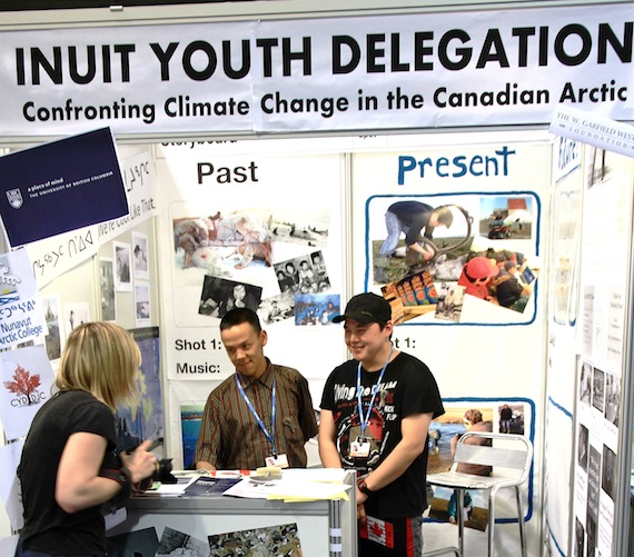 Jordan Konek and Curtis Kuunaq of Nanisiniq Arviat history project talk to a visitor at their booth at the United Nations climate change summit now underway in Durban, South Africa. Read more about their experiences in Durban at Nunatsiaqonline.ca. (PHOTO BY FRANK TESTER)
