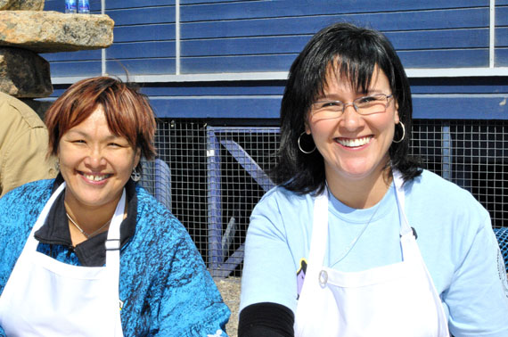 Here Okalik Eegeesiak (left), who was re-elected as president of the Qikiqtani Inuit Association on Dec. 12, and Leona Aglukkaq, the MP for Nunavut, serve barbecued food in Iqaluit on Nunavut Day 2011. (FILE PHOTO)