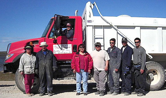 Sudliq Developments Ltd. of Coral Harbour, whose workers are shown here by one of the company's trucks, won its appeal with the Nunavummi Nangminiqaqtunik Ikajuuti appeals board against the Government of Nunavut’s decision to grant the fuel contract to Katudgevik Co-op Ltd., part of the Arctic Co-operatives Ltd. network.  (FILE PHOTO)
