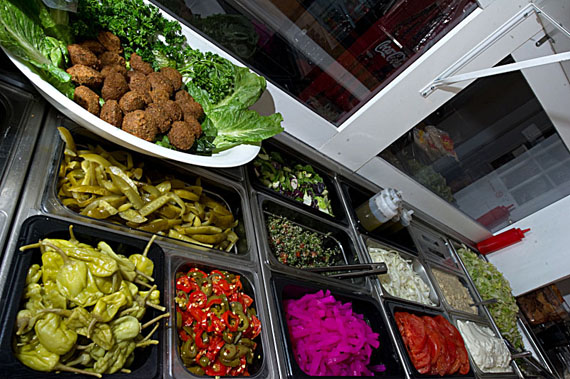 Some of the fixings that go into a shawarma: tomatoes, hot peppers, tahini, hummus, falafel — even pickled turnips. (PHOTO COURTESY OF YUMMY SHAWARMA)