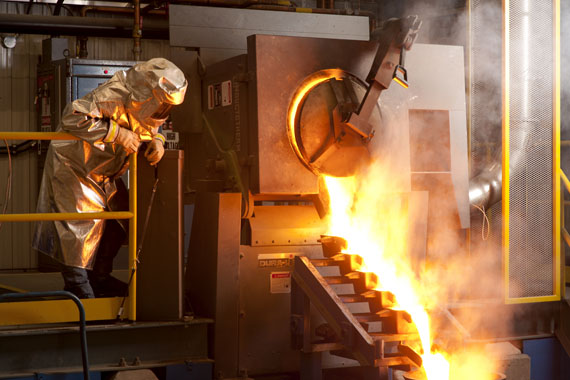 Here a worker at Agnico-Eagle's Meadowbank gold mine in Baker Lake, Nunavut, which poured its first gold bar in 2010, watches as gold streams into a mold. On Feb. 15 Agnico-Eagle Mines Limited reported a quarterly net loss of $601.4 million, or a loss of $3.53 per share for the fourth quarter of 2011. Read more about this development on nunatsiaqonline.ca. (FILE PHOTO)