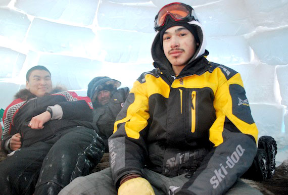 Elijah Aitaok, Paul Billows and Luc-Paul Uvilloq relax in an igloo during the Kitikmeot Heritage Society winter camp, which has seen igluit erected outside the community of Cambridge Bay under the guidance of elders. Elders were looking forward to spending the night at the camp, while a group of students from Kiilinik High School visited on Feb. 24. (PHOTO BY BRENDAN GRIEBEL)