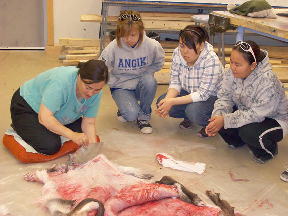 Retired teacher Sarah Takolik often returns to school to make Inuktitut materials for the Department of Education and to share her knowledge with students. She is pictured here with Anna Wolki, Gail Poodlat and Junette Kingmeaqtuq. (FILE PHOTO)