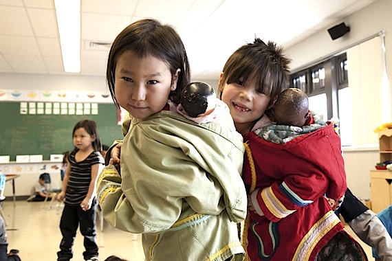 These girls in a Puvirnituq kindergarten class play with dolls, putting them in their amautiks. (PHOTO COURTESY OF LA PRESSE)