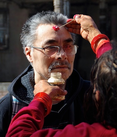 Laimikie Palluq gets a “tika” at a temple in Kathmandu. The tika represents the