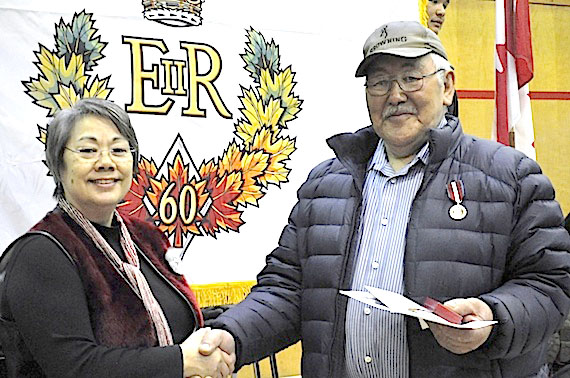 Nunavut Premier Eva Aariak presents a Diamond Jubilee medal to Sandy Akavak of Kimmirut. The medal recognizes Akavak's contribution to the well-being of Nunavummiut and Nunavut and for his service as a special constable with the RCMP, an April 4 Government of Nunavut news release said. In 2012 Aariak will give out 55 of these medals, issued during the 60th anniversary year of Queen Elizabeth II's reign, to outstanding Nunavummiut. (PHOTO COURTESY OF THE GN)