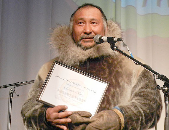 Solomon Awa, leader of the successful bowhead whale hunt near Iqaluit this past August, accepts a certificate honouring his selection as this year's honorary Toonik. Toonik Tyme kicked off April 12 in the city's curling rink with an evening of music hosted by Anguti Johnson. More photos and information about Toonik Tyme April 13 on Nunatsiaqonline.ca. (PHOTO BY JANE GEORGE)
