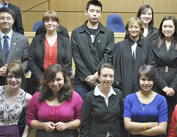 Justice Marie Deschamps of the Supreme Court of Canada (second from right, middle row) poses with some Grade 10 students from Iqaluit's Inuksuk High School at the Nunavut Court of Justice on April 2. Justice Deschamps presided over a moot court trial on April 2 of a young woman accused of stealing a snowmobile, while students from Kim Masson's class played the roles of lawyers, court workers and witnesses. Read more about the 