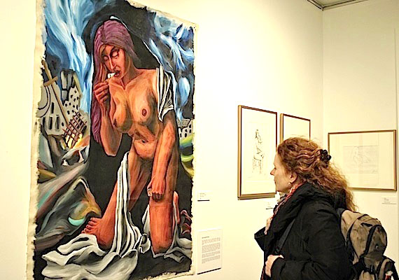 Rannva Simonsen of Iqaluit looks at a painting, called Woman Smoking, by her son Bjorn Simonsen, which is on display at the Nunatta Sunakkutangit Museum in Iqaluit until May 20, along with other prints, paintings and drawings by other visual artists in Iqaluit. (PHOTO BY JANE GEORGE)