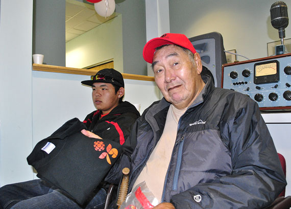 The late Jonah Kelly, at an open house held at the CBC building in Iqaluit Oct. 1, 2011, displays a tee shirt marking the Canadian Broadcasting Corp.'s 75th anniversary year in 2011. Kelly, an Inuit-language broadcasting pioneer who served the eastern Arctic for 31 years while working for CBC in Iqaluit, died May 26 at an Ottawa hospital. (PHOTO BY JIM BELL)