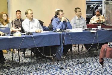 Baffinland Iron Mines Corp. representatives,  (from left to right) Greg Missal, Erik Madsen and Oliver Curran, listen May 3 to the proceedings of the technical meeting in Iqaluit. (PHOTO BY JIM BELL) 