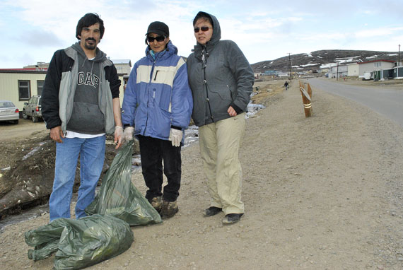 Proud Iqalummiut keeping their community clean: Tony Ashoona, Luukie Markoosie and Minnie Nookiguak of Iqaluit are among many volunteers from the Tukisigiarvik centre who began a big cleanup of the little creek valley that runs by the hospital to the beach. (PHOTO BY JIM BELL)