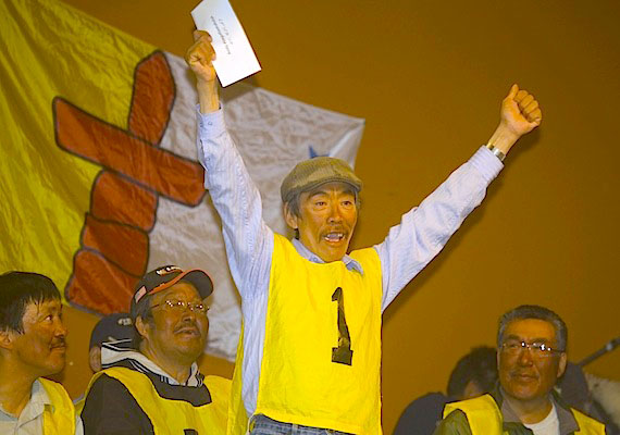 In the winners' circle: Nunavut Quest winner Andy Attagutaaluttuk of Igloolik celebrates May 11 at an Arctic Bay ceremony after winning the dog team race across north Baffin from Igloolik to Arctic Bay in 40 hours, 12 minutes and nine seconds. Andrew Taqtu of Arctic Bay came in second at 42 hrs, eight minutes and 45 seconds and Peter Siakuluk of Hall Beach came third in at 43 hrs, five mins and 44 seconds. (PHOTO BY CLARE KINES)
