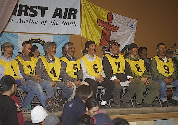 The dog team racers, (from left to right) Andy Attagutaaluttuk, Kevin Attagutaaluttu, Peter Siakuluk, Andrew Muckpa, Joeli Qaunaq, Moses Oyukuluk, Jonah Qaunaq and Titus Alooloo, who finished the Nunavut Quest dog team race from Igloolik to Arctic Bay received praise and prizes May 10 in Arctic Bay. (PHOTO BY CLARE KINES)