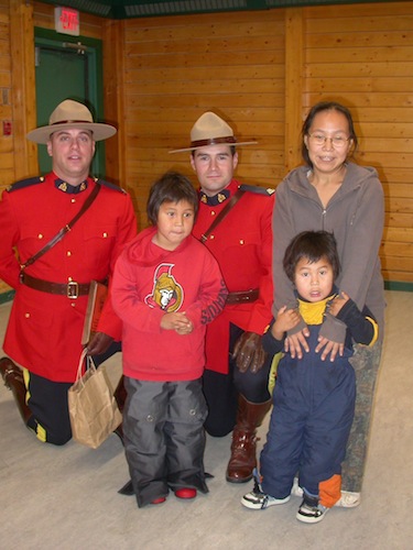 RCMP members Dave Brown and Greg Redl stand with Katie Anavilok and her sons Andrew Anavilok and Alexander Anavilok on Oct. 19, 2010 in Cambridge Bay’s Luke Novoligak community centre where the two members were honoured for quick action on July 9, 2010 which saved seven-year old Andrew from drowning. (FILE PHOTO)