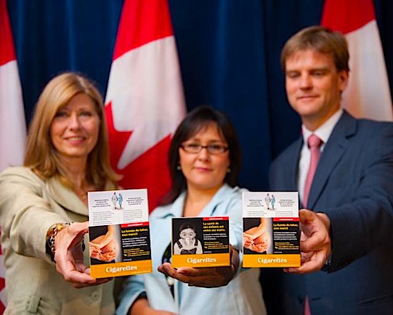 Leona Aglukkaq, Nunavut MP and federal health minister (centre), unveils the designs for new tobacco packaging, with Bobbe Wood, president of the Heart and Stroke Foundation (left) and Chris Alexander, MP for Ajax-Pickering (right). (PHOTO COURTESY OF L. AGLUKKAQ)