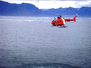 A Canadian Coast Guard helicopter flies an ice reconnaissance mission over Frobisher Bay on July 31.  The Canadian Coast Guard has been busy escorting several ships through the heavy ice pack in the bay.  (PHOTO COURTESY OF ENVIRONMENT CANADA)