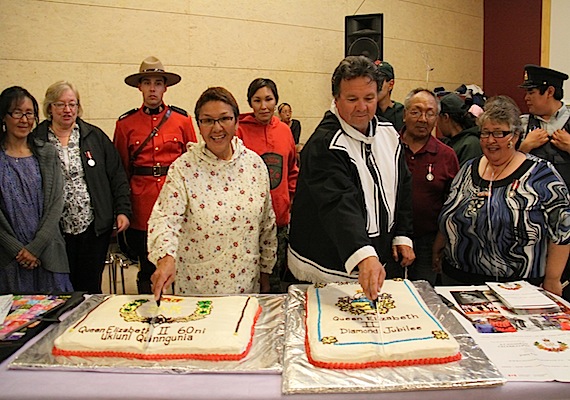 Nunavut Commissioner Edna Elias and Peter Taptuna, Nunavut's economic development minister and MLA for Kugluktuk, cut cakes made for a community celebration in Kugluktuk held earlier this month when Colin Adjun, Simon and Millie Kuliktana, Barbara Elaine Harvey and Thomas Mark Harvey received  Queen Elizabeth ll Diamond Jubilee medals. Read more about the ceremony later on Nunatsiaqonline.ca. (PHOTO COURTESY OF THE GOVERNMENT OF NUNAVUT)