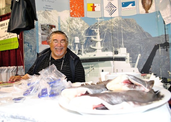 Ben Kovic of the Baffin Fisheries Coalition shows off a plate loaded with freshly-caught turbot at Nunavut Trade Show Sept. 27. (PHOTO BY JIM BELL)
