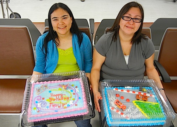 Darleen Qamukkaq and Lorna Gee of Gjoa Haven hold special birthday cakes for their children at the Yellowknife airport as they wait for their flight home on Sept. 23. The cakes finally made it to Gjoa Haven Sept. 23,  but too late for the planned birthday parties. The cakes arrived nearly two days late, due to a cancelled flight on Sept. 22 and another delay on Sept. 23 when mechanical issues forced the aircraft to turn back to Yellowknife after more than two hours in the air. The two mothers, along with other passengers on their flight, received $200 vouchers to use towards a future First Air flight as compensation for the inconvenience. (PHOTO BY JANE GEORGE)
