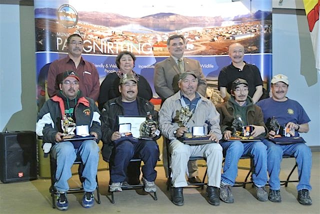 Six long-serving firefighters from the Pangnirtung Fire Department received the Governor General's Fire Services Exemplary Service Medal Oct. 26 in Pangnirtung. From left to right, front: Larry Dialla, Jonah Akulukjuk, Tim Dialla, David Uniukshagak, Norman Nowyook; from left to right, back, Pangnirtung MLA, Hezekiah Oshutapik, Monica Ell, Nunavut's minister of Human Resources, Lorne Kusugak, Nunavut's minister of Community and Government Services, and Sakiasie Sowdluapik, mayor of Pangnirtung. Missing from photo: Robert Dialla. (PHOTO COURTESY OF THE GOVERNMENT OF NUNAVUT)


