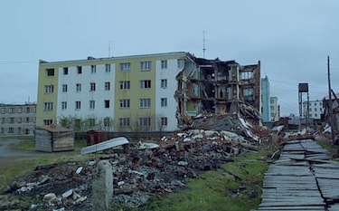 The destruction of melting permafrost: uneven settling due to permafrost thaw destroyed this apartment building in Cherski, Siberia, which occurred only days after the appearance of the first cracks. (PHOTO COURTESY OF UNEP)
