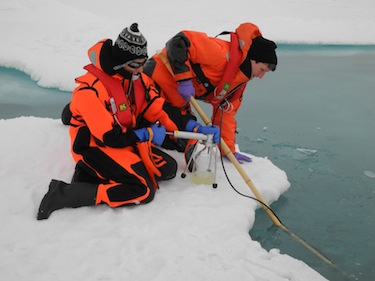 Researchers use high-tech equipment to study ice algae under a melt pond in the central Arctic Ocean. (PHOTO COURTESY OF THE ALBERT WEGENER INSTITUTE)
