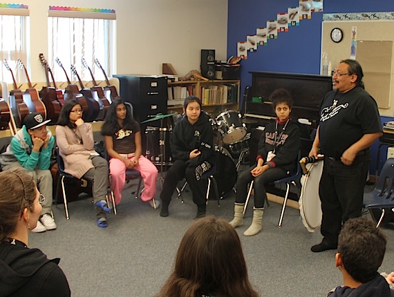 Music students from Ottawa learn about Inuit drums and hunting from Mathew Nuqingaq at the Aqsarniit Middle School in Iqaluit March 14. The group of Ottawa students, who arrived right before the March 11 blizzard March, have since performed with the Iqlauit Fiddle Club, gone dog-sledding, played ice soccer and toured the legislative assembly building. The program, called Orkidstra, will see Iqaluit students go to Ottawa in April to play music. The group will perform a concert Friday, March 15 at 7:30 p.m. at Nakasuk School. (PHOTO BY SAMANTHA DAWSON) 